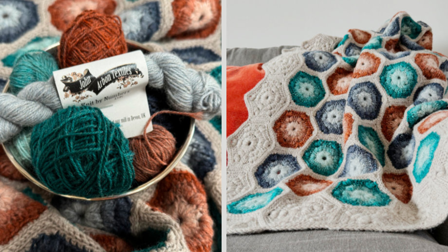 A blanket comprised of multiple gradient hexagons in teal, blue and rust, bordered with beige.